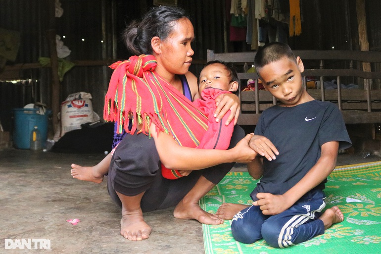 VietNam – Couple living in makeshift tents, carrying disabled children to herd rented cows